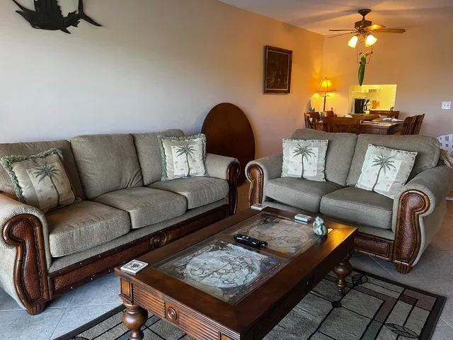 a living room with furniture and a lamp