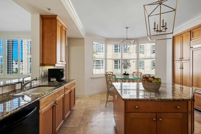a kitchen with granite countertop a sink and cabinets