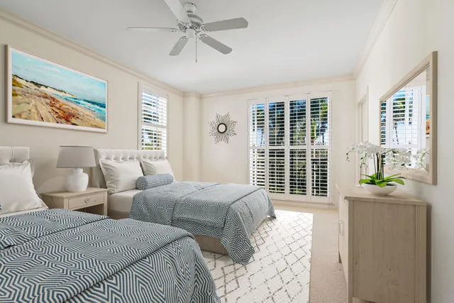 a bedroom with two beds and a large window