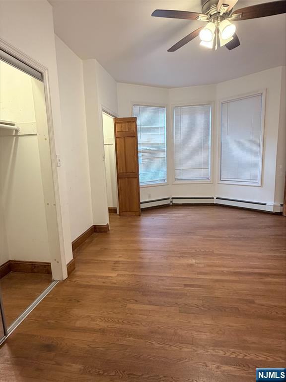 242 Grant Avenue, Unit 2 East Newark, NJ 07029 - Photo 1 of 9 a view of an empty room with wooden floor and a window