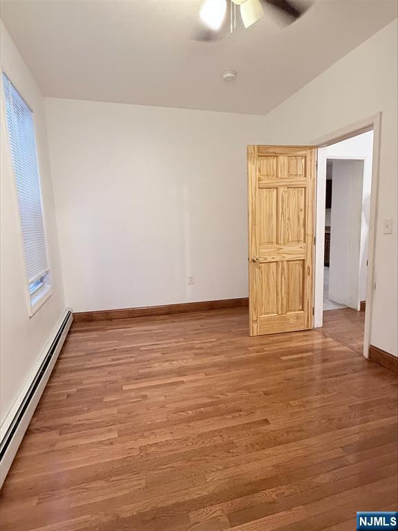 242 Grant Avenue, Unit 2 East Newark, NJ 07029 - Photo 8 of 9 a view of an empty room with wooden floor and a window