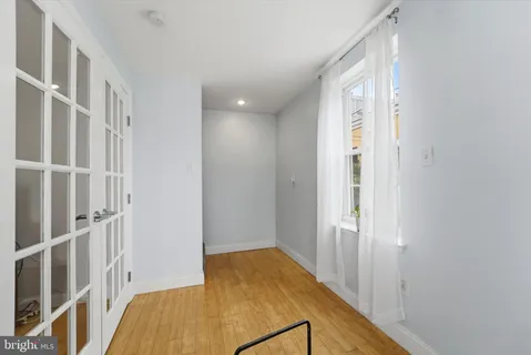 a bedroom with a bed and a ceiling fan