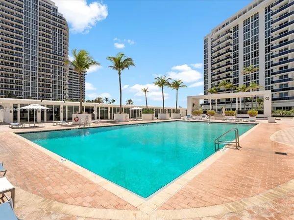 a view of swimming pool with outdoor space and seating area