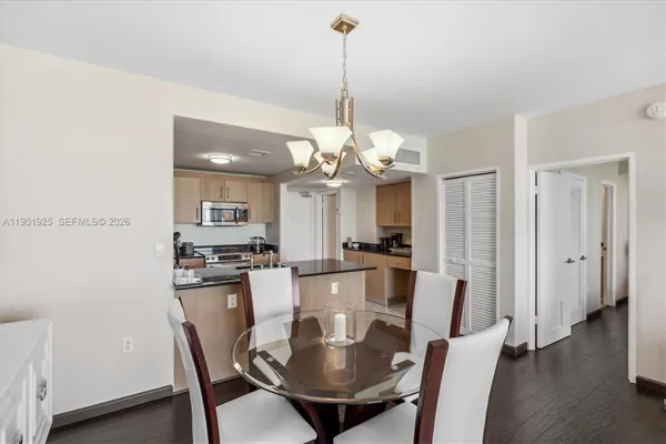 a dining room with furniture a chandelier and wooden floor
