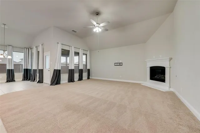 a view of an empty room with a fireplace