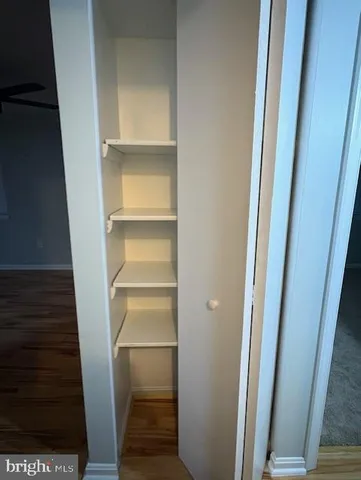 a view of walk in closet with empty racks