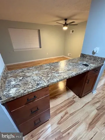 a view of a kitchen counter space and a sink