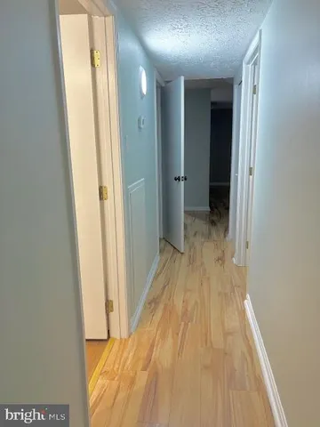 a view of a room with wooden floor