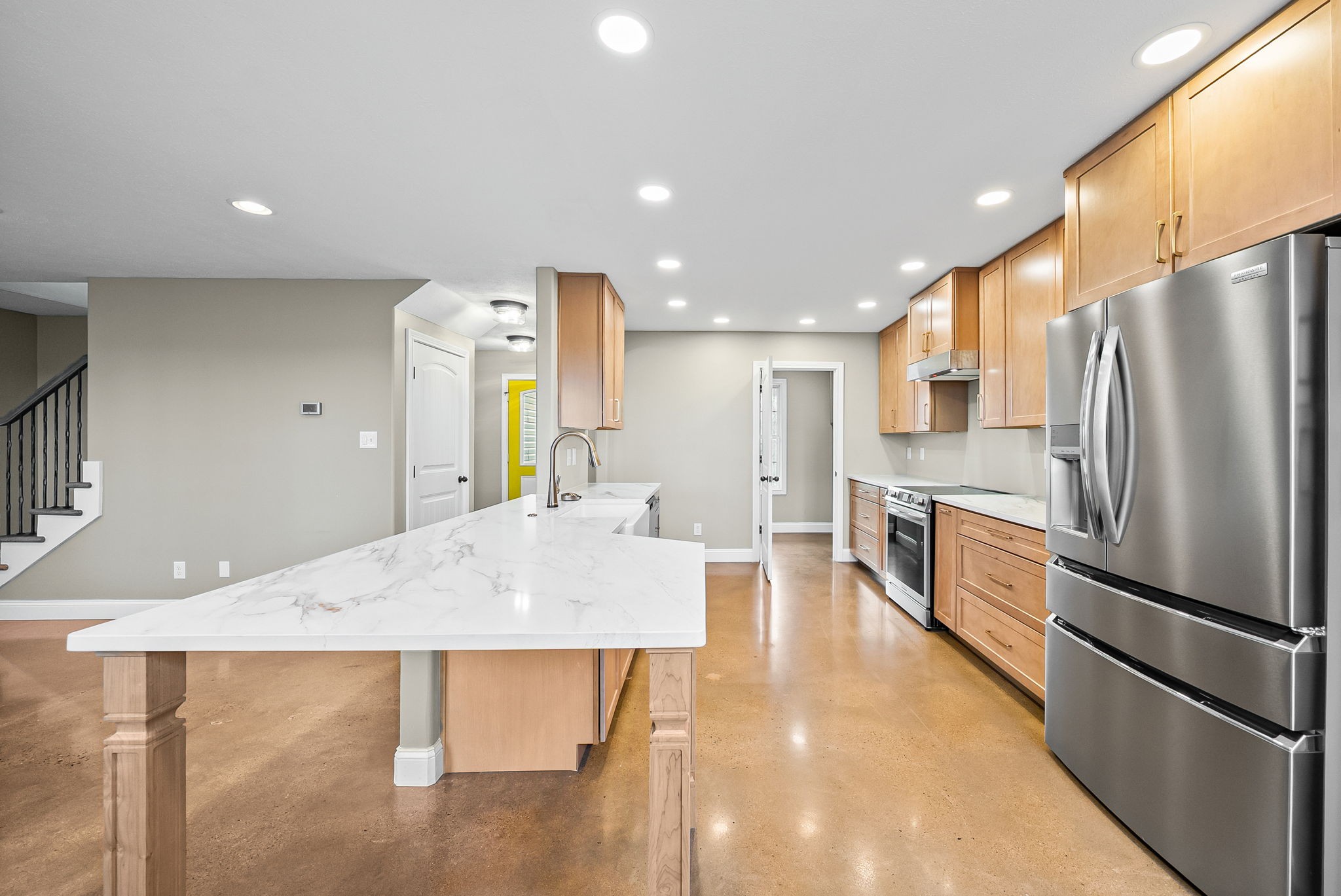 1903 East Boy Scout Road Clarksville, TN 37042 - Photo 11 of 36 a large kitchen with stainless steel appliances kitchen island a large counter top and a refrigerator