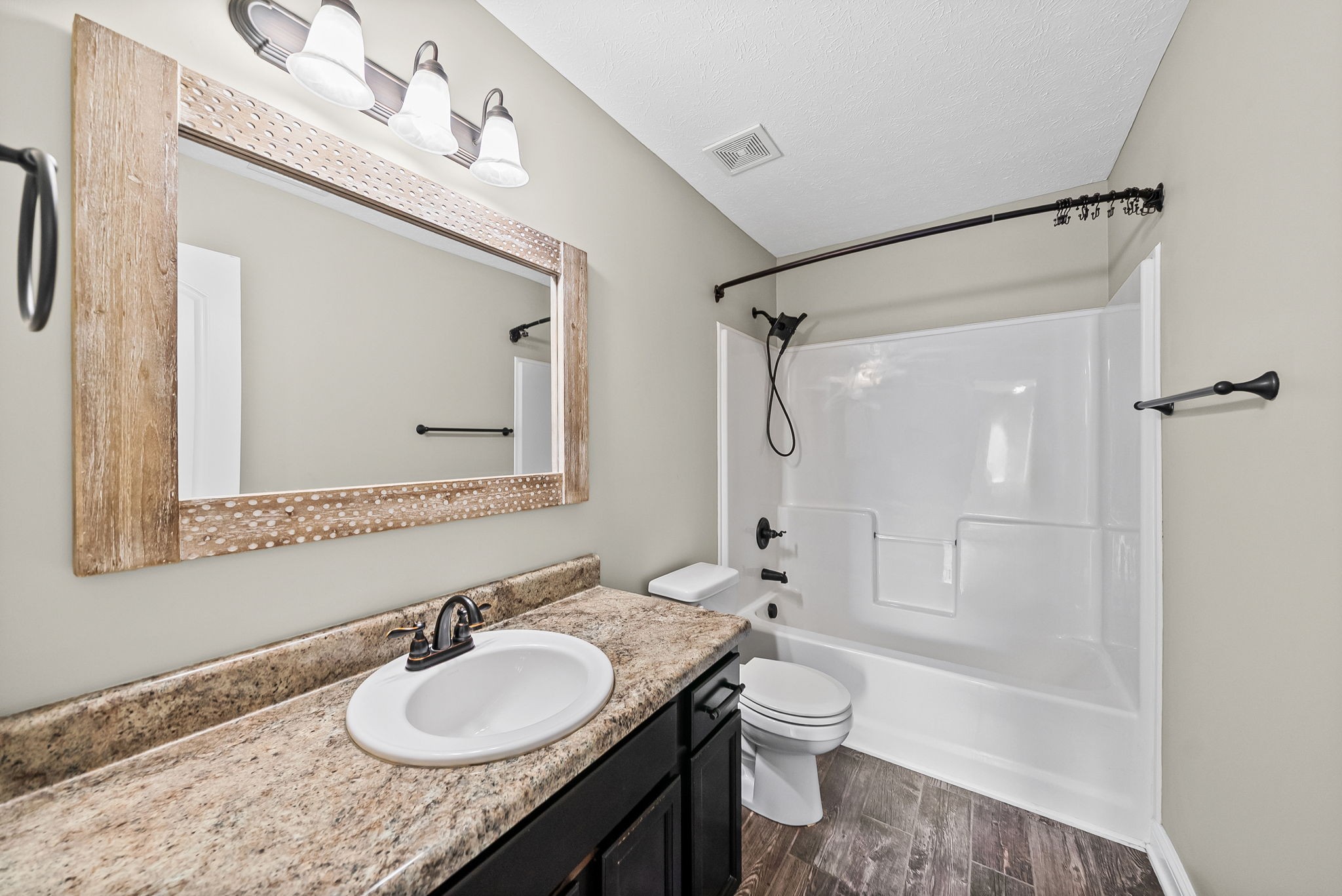 1903 East Boy Scout Road Clarksville, TN 37042 - Photo 28 of 36 a bathroom with a granite countertop sink toilet a mirror a vanity and shower