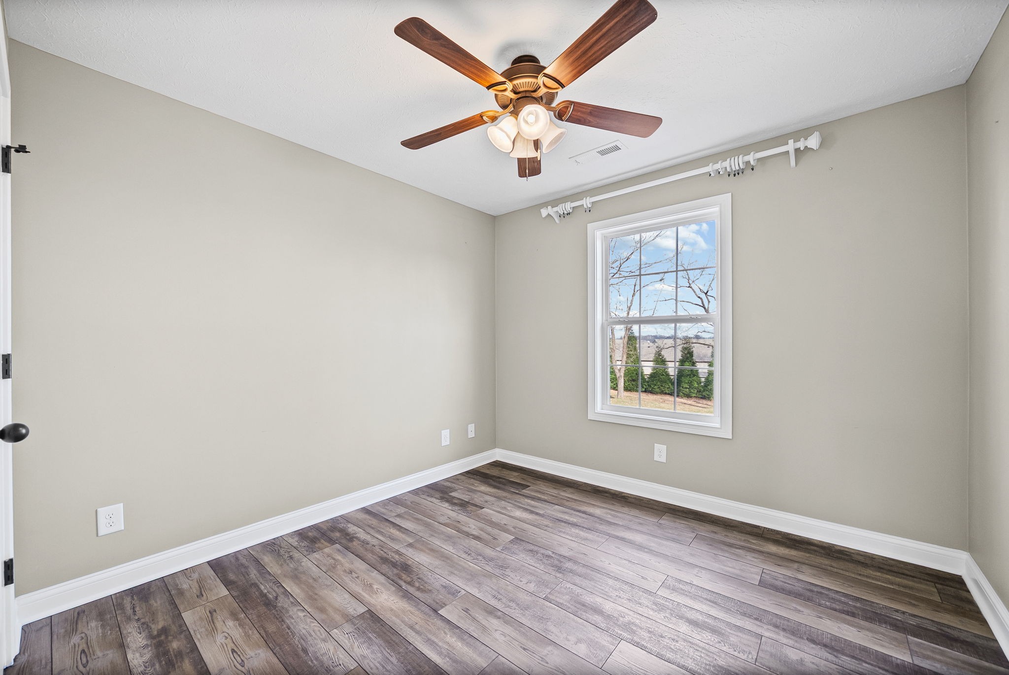 1903 East Boy Scout Road Clarksville, TN 37042 - Photo 29 of 36 an empty room with wooden floor and ceiling fan