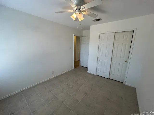 a view of empty room with fan