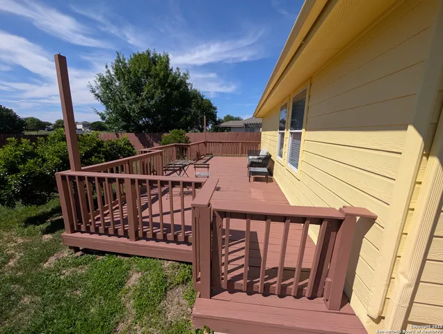 a view of a wooden deck with a fence