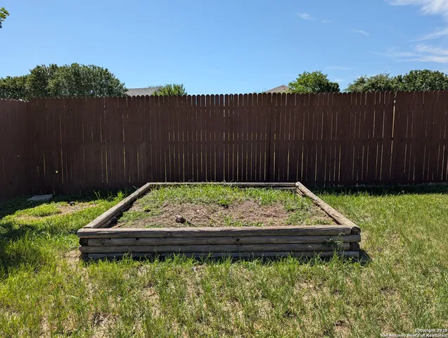a wooden bench sitting in the middle of a garden