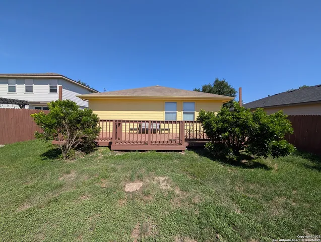 a view of a house with a yard and deck