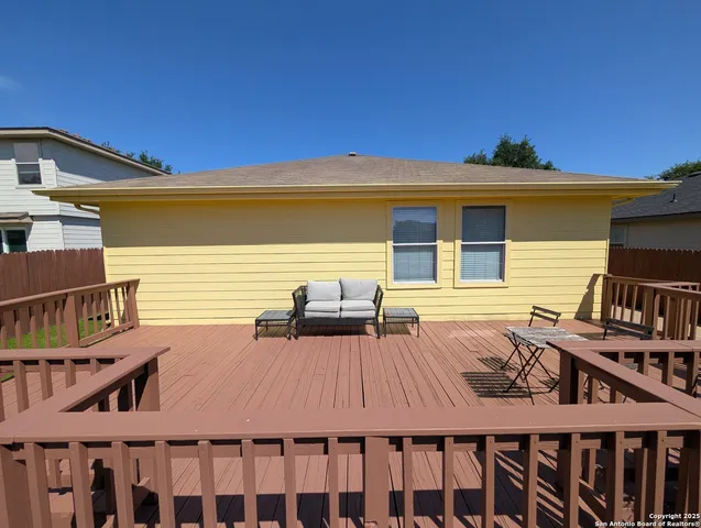 a view of a roof deck with wooden floor and fence