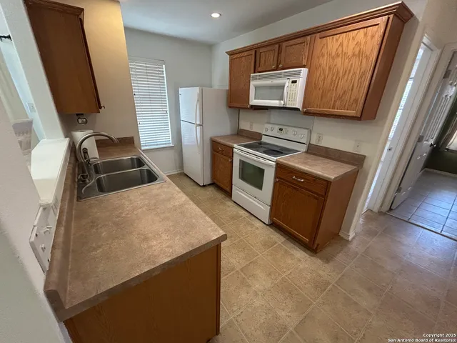 a kitchen with stainless steel appliances a stove microwave and sink