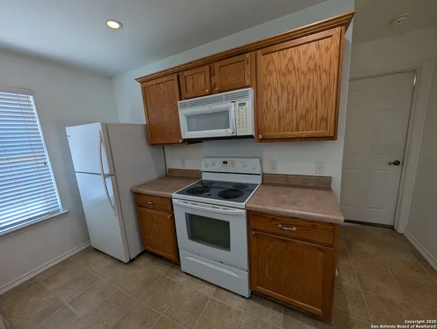 a kitchen with a stove and a microwave