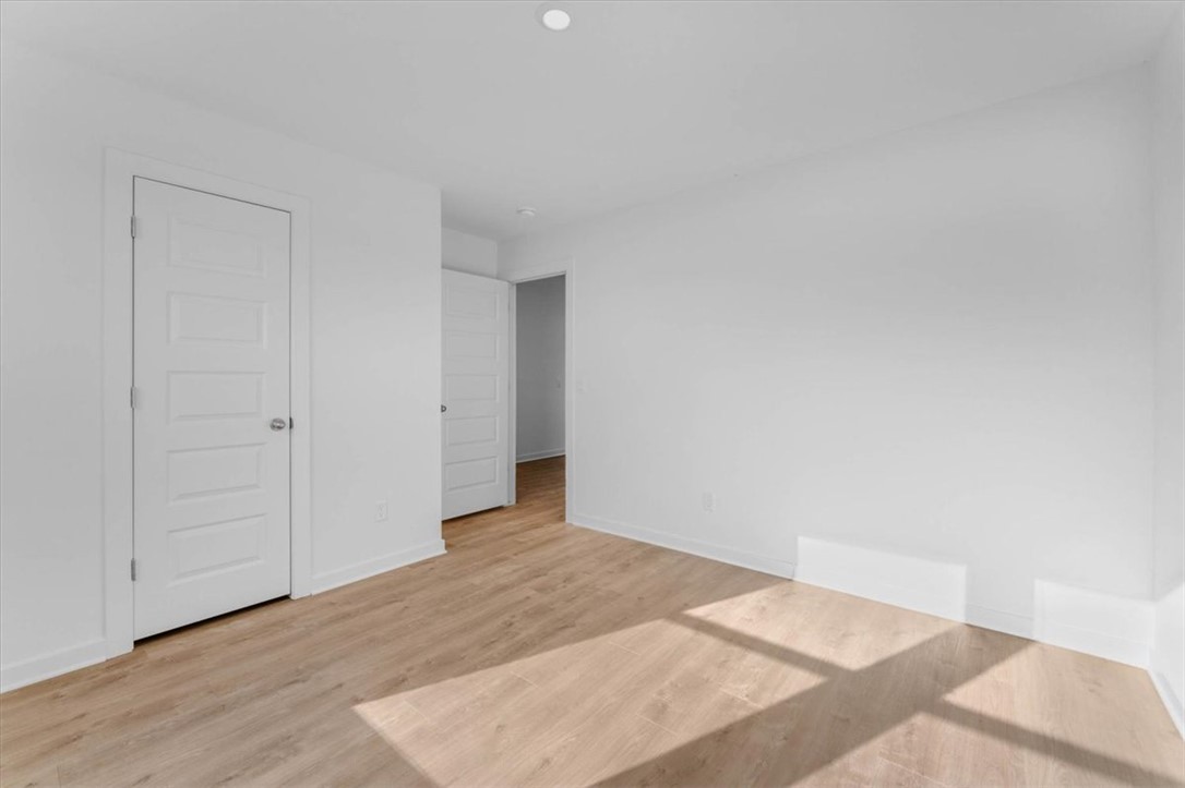 550 Riggs Street Prairie Grove, AR 72753 - Photo 8 of 29 Recessed ceiling light, light wood-finish flooring, white walls, white doors with modern paneling
