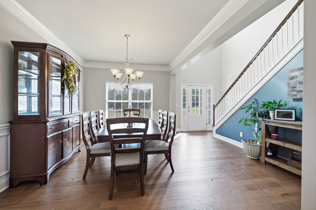 511 Cromer Road Townville, SC 29689 - Photo 11 of 45 Elegant hardwood flooring extends through this welcoming dining area, leading to a grand staircase.