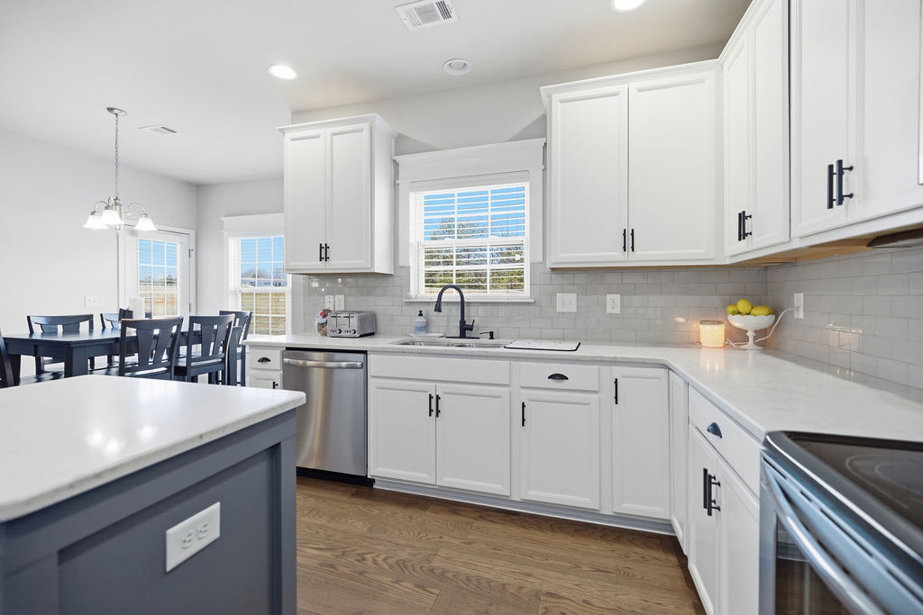 511 Cromer Road Townville, SC 29689 - Photo 14 of 45 This modern kitchen features crisp cabinetry, essential appliances, and an inviting dining area.