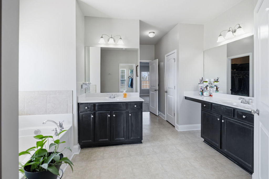 511 Cromer Road Townville, SC 29689 - Photo 22 of 45 This spacious bathroom offers dual vanities and a relaxing soaking tub for ultimate comfort.