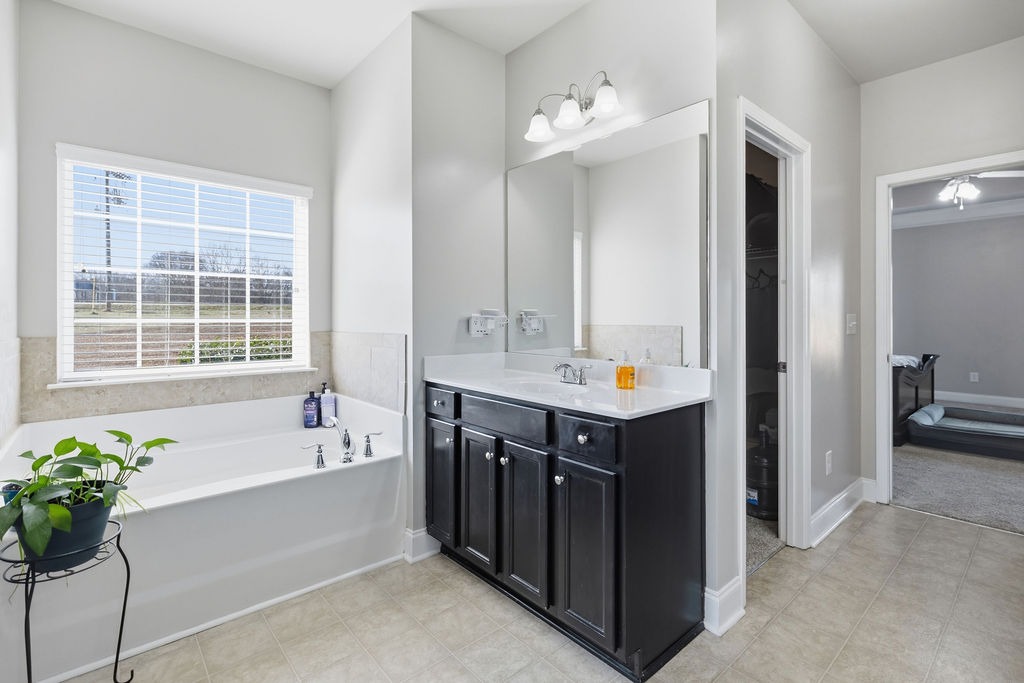 511 Cromer Road Townville, SC 29689 - Photo 23 of 45 This serene bathroom offers a spacious soaking tub and a functional vanity for daily routines.