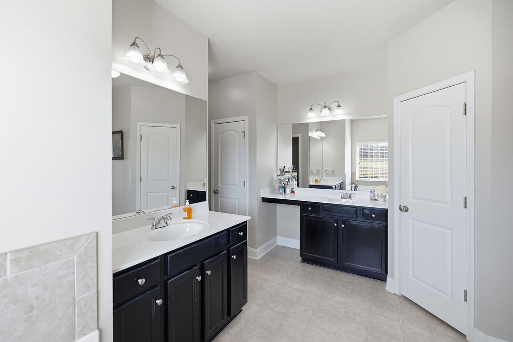 511 Cromer Road Townville, SC 29689 - Photo 25 of 45 This spacious bathroom offers dual vanities with ample storage and bright lighting.