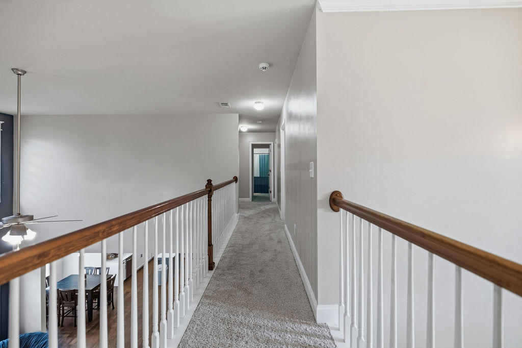 511 Cromer Road Townville, SC 29689 - Photo 29 of 45 This interior hallway features a cozy carpet and a well-lit path to the adjoining rooms.