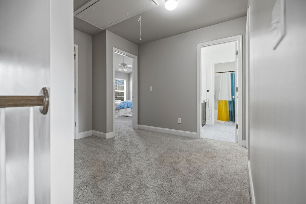 511 Cromer Road Townville, SC 29689 - Photo 33 of 45 This spacious hallway connects rooms, offering comfort with carpet flooring and ample lighting.