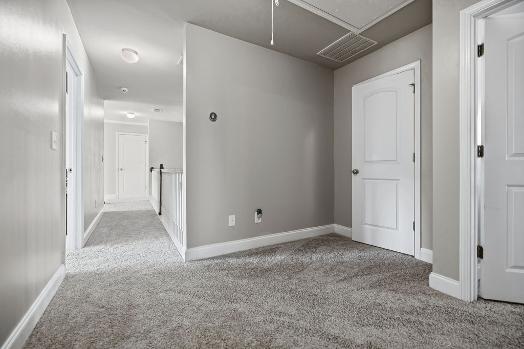 511 Cromer Road Townville, SC 29689 - Photo 36 of 45 This carpeted hallway connects various spaces, offering a neutral backdrop for any design vision.