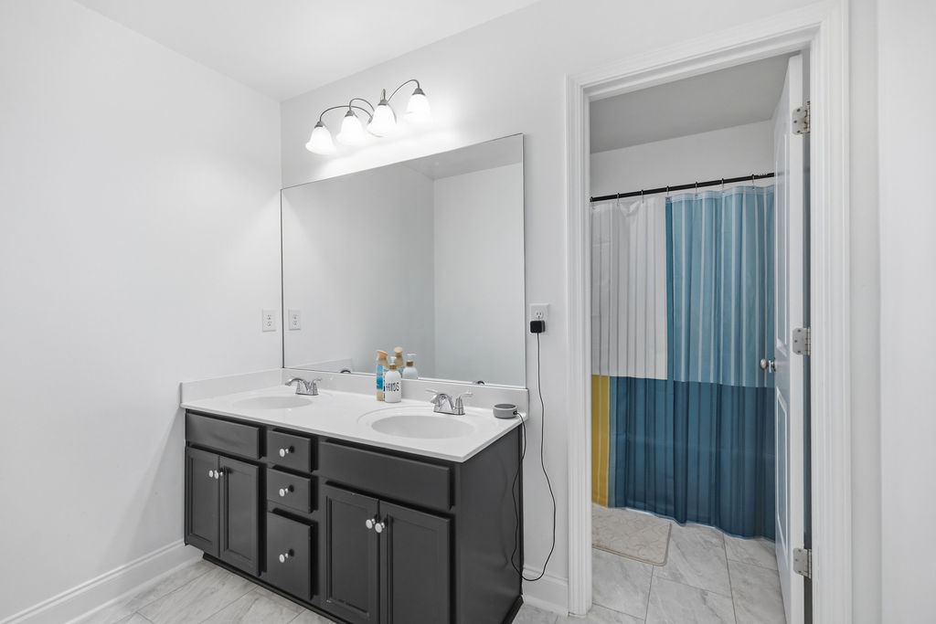 511 Cromer Road Townville, SC 29689 - Photo 37 of 45 This bathroom offers a double vanity with ample counter space and a clean, functional design.