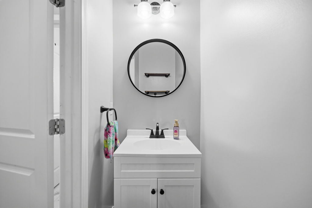 511 Cromer Road Townville, SC 29689 - Photo 42 of 45 This clean and bright bathroom features a modern vanity and a sleek circular mirror.