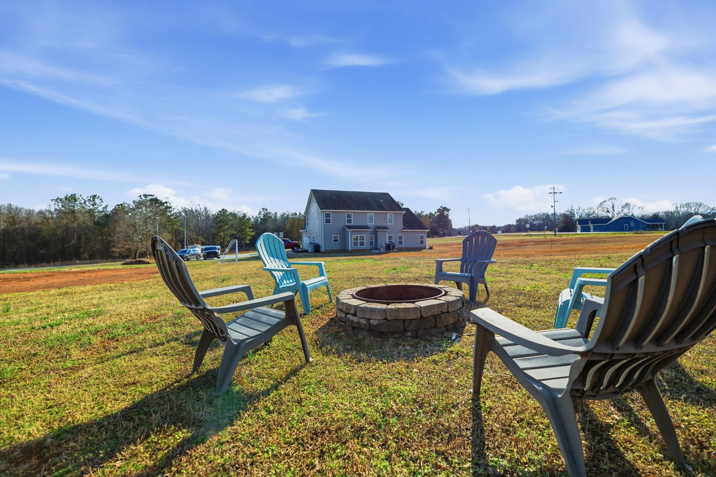 511 Cromer Road Townville, SC 29689 - Photo 43 of 45 This spacious backyard offers a perfect gathering spot for outdoor enjoyment around the fire pit.
