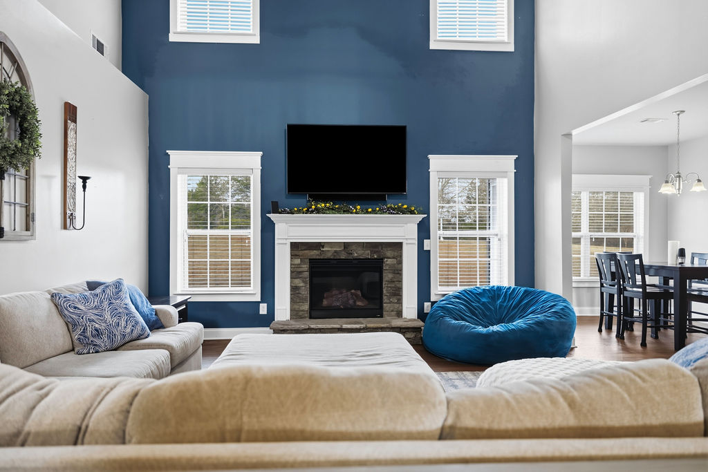 511 Cromer Road Townville, SC 29689 - Photo 6 of 45 This inviting living space features a cozy fireplace, tall ceilings, and ample natural light.