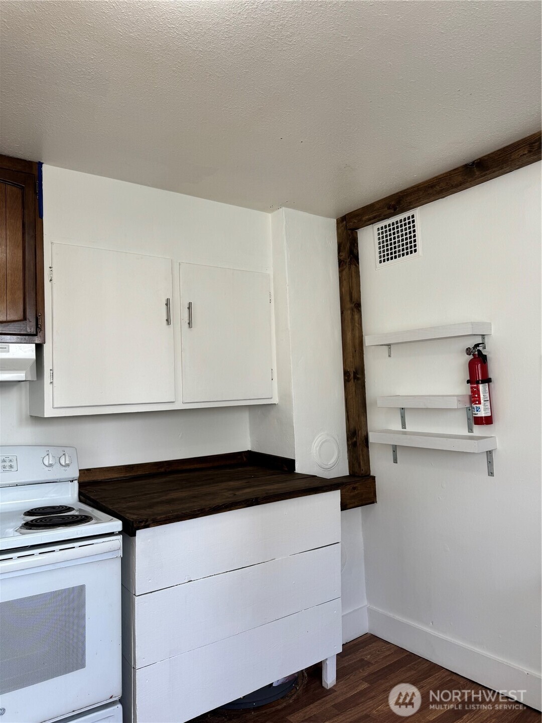 61 North Kean Street Republic, WA 99166 - Photo 17 of 34 a kitchen with a stove and white cabinets