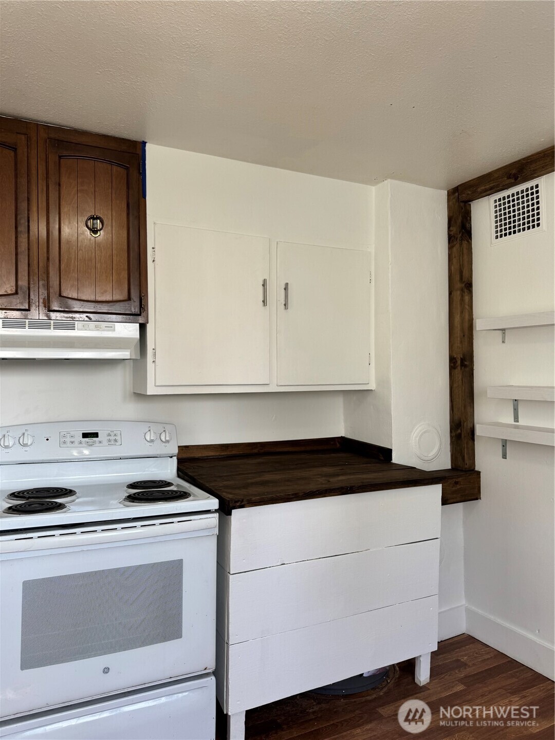 61 North Kean Street Republic, WA 99166 - Photo 18 of 34 a close view of a stove a microwave and cabinets