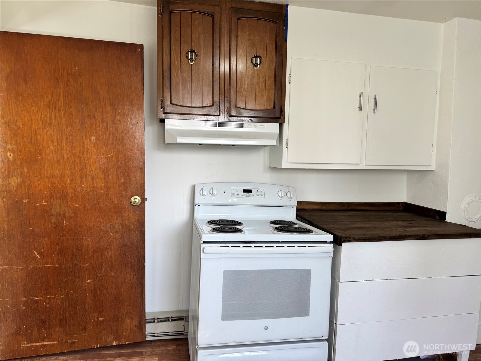 61 North Kean Street Republic, WA 99166 - Photo 19 of 34 a kitchen with granite countertop a sink a stove and cabinets