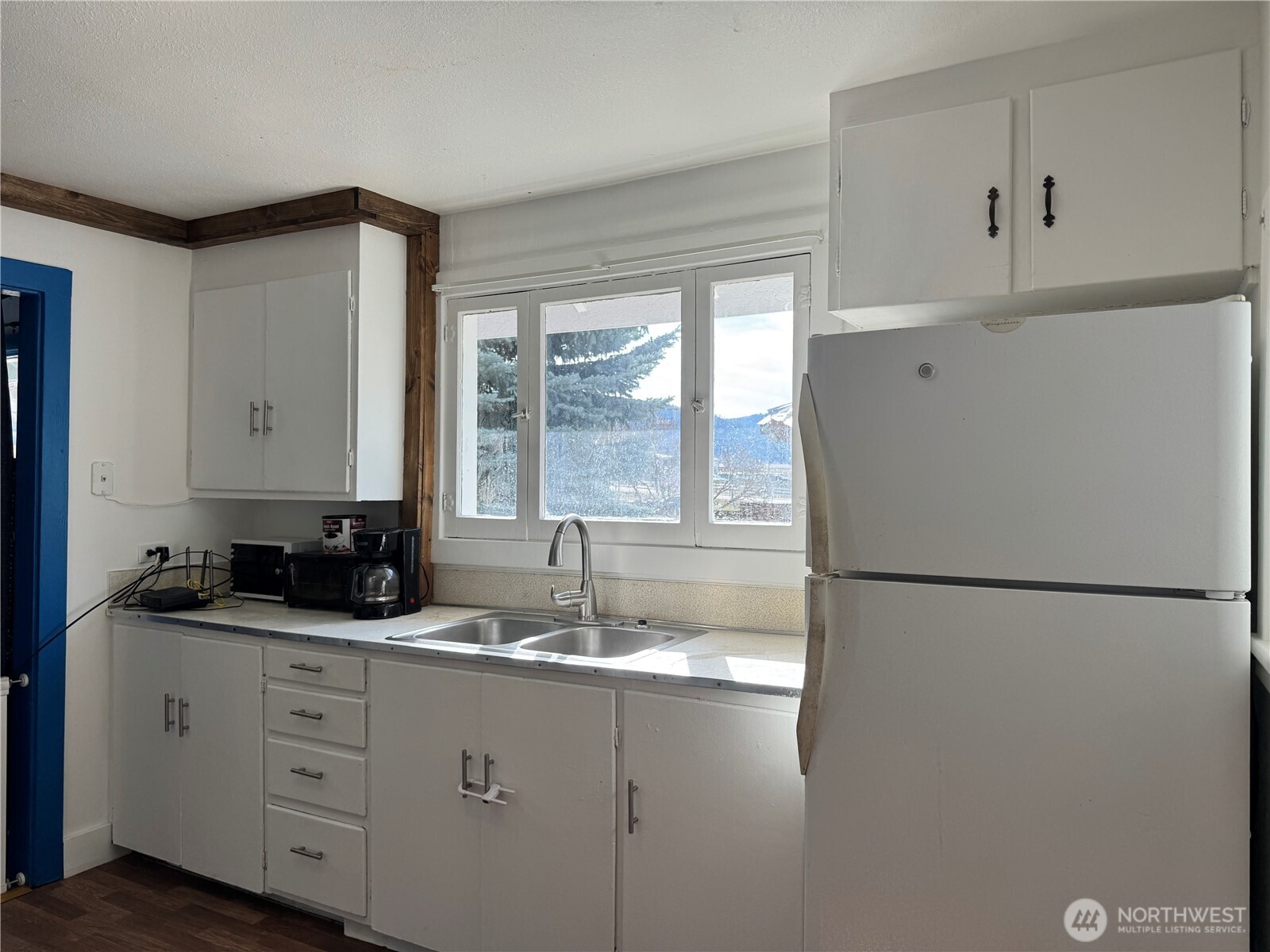 61 North Kean Street Republic, WA 99166 - Photo 5 of 34 a kitchen with cabinets appliances a sink and a window