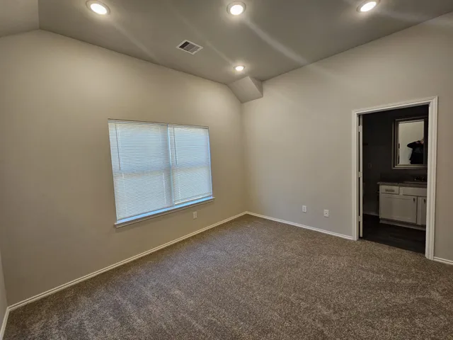 an empty room with a bathroom and a sink
