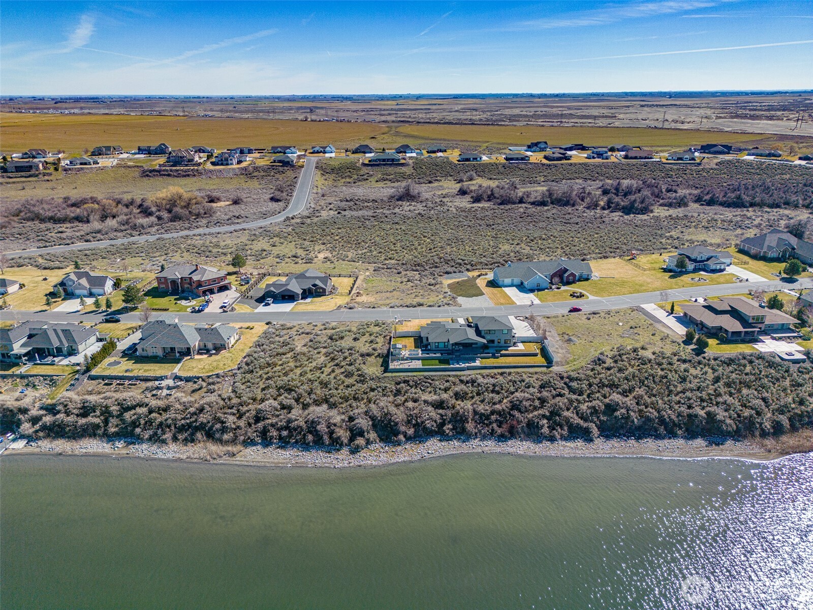 7382 Dune Lake Road Southeast Moses Lake, WA 98837 - Photo 6 of 13 a view of a lake with a car parked in the ocean