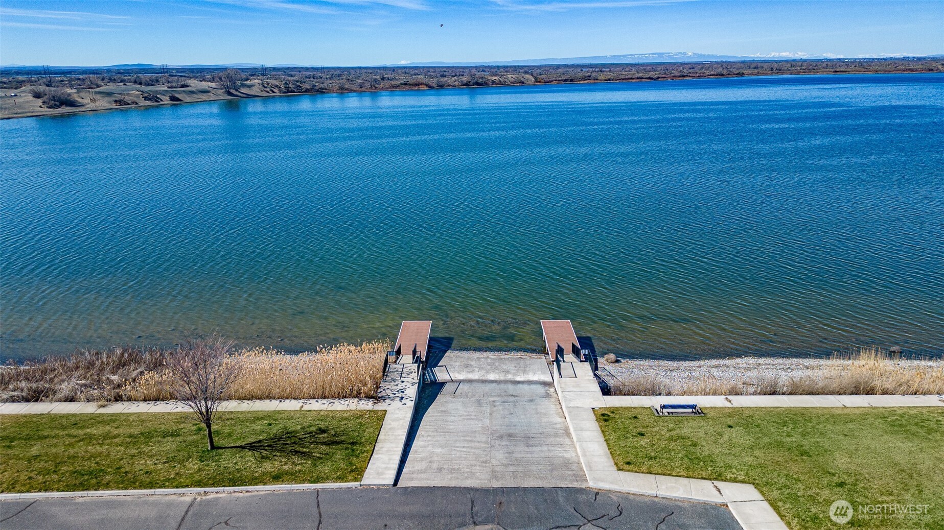 7382 Dune Lake Road Southeast Moses Lake, WA 98837 - Photo 10 of 13 a view of a lake with a big yard
