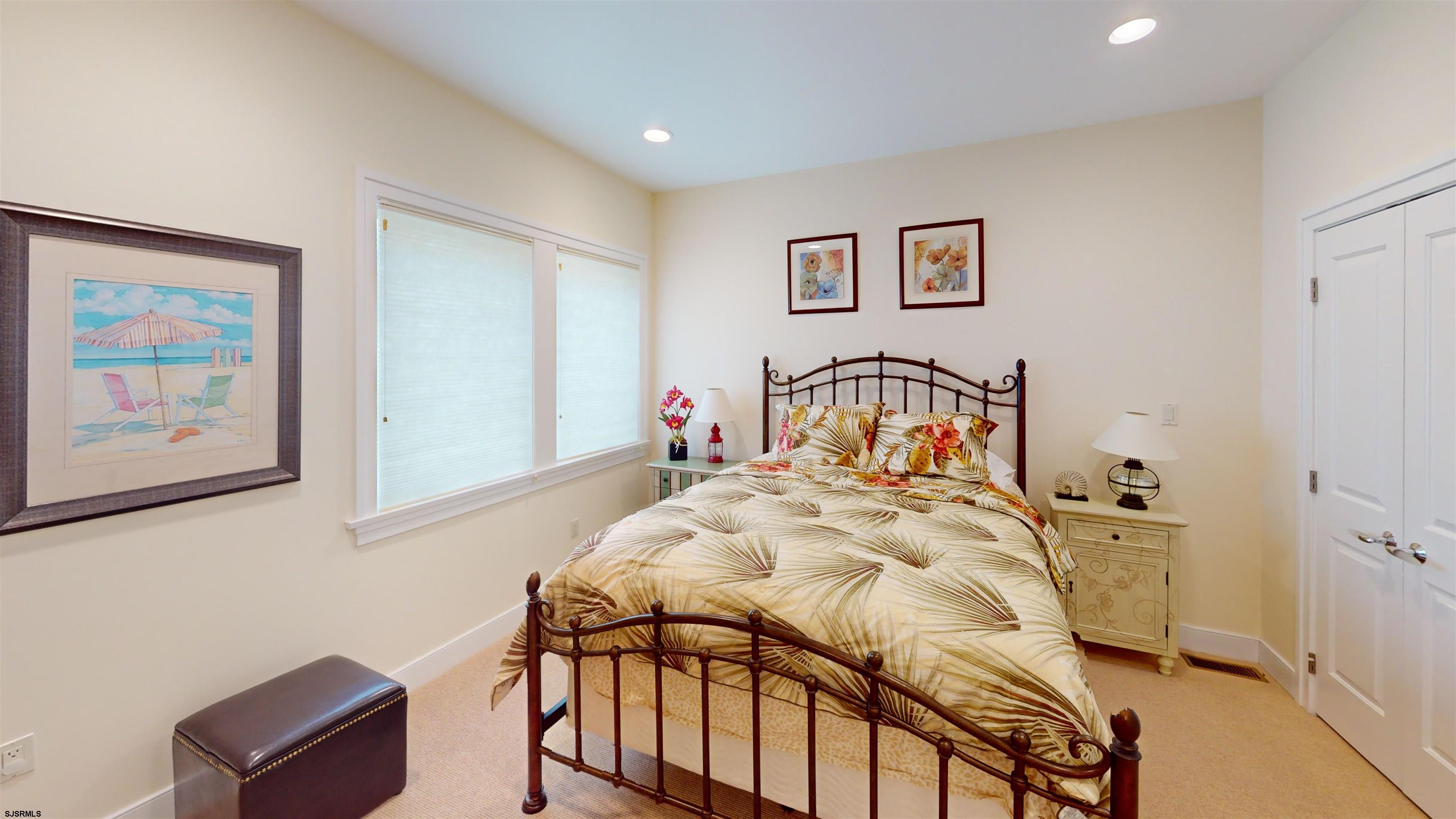 214 North Decatur Avenue, Unit 3B Margate City, NJ 08402 - Photo 14 of 41 a bedroom with a bed and a painting on the wall