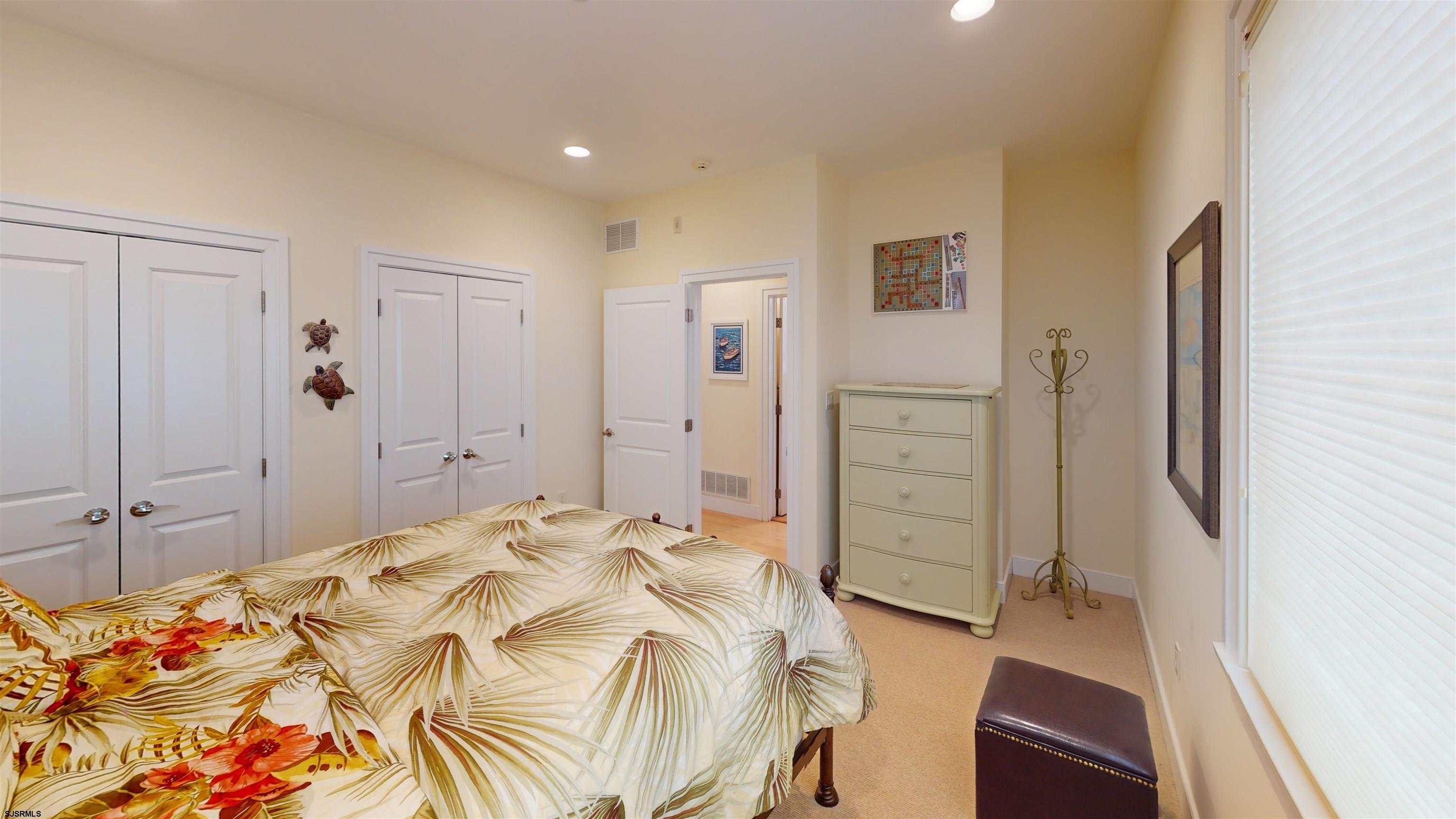 214 North Decatur Avenue, Unit 3B Margate City, NJ 08402 - Photo 15 of 41 a bedroom with a bed and a dresser
