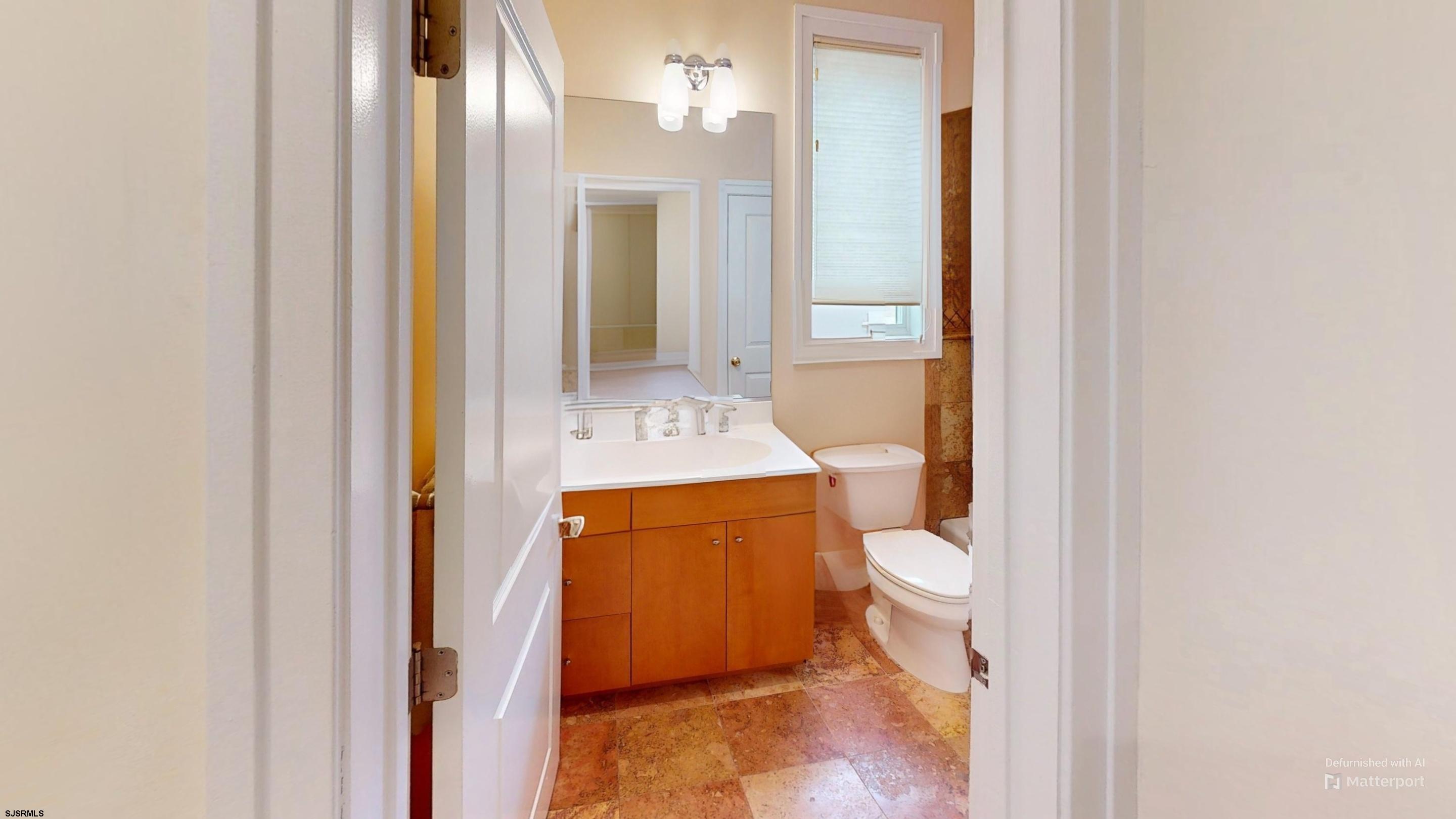 214 North Decatur Avenue, Unit 3B Margate City, NJ 08402 - Photo 16 of 41 a bathroom with a granite countertop toilet and a sink
