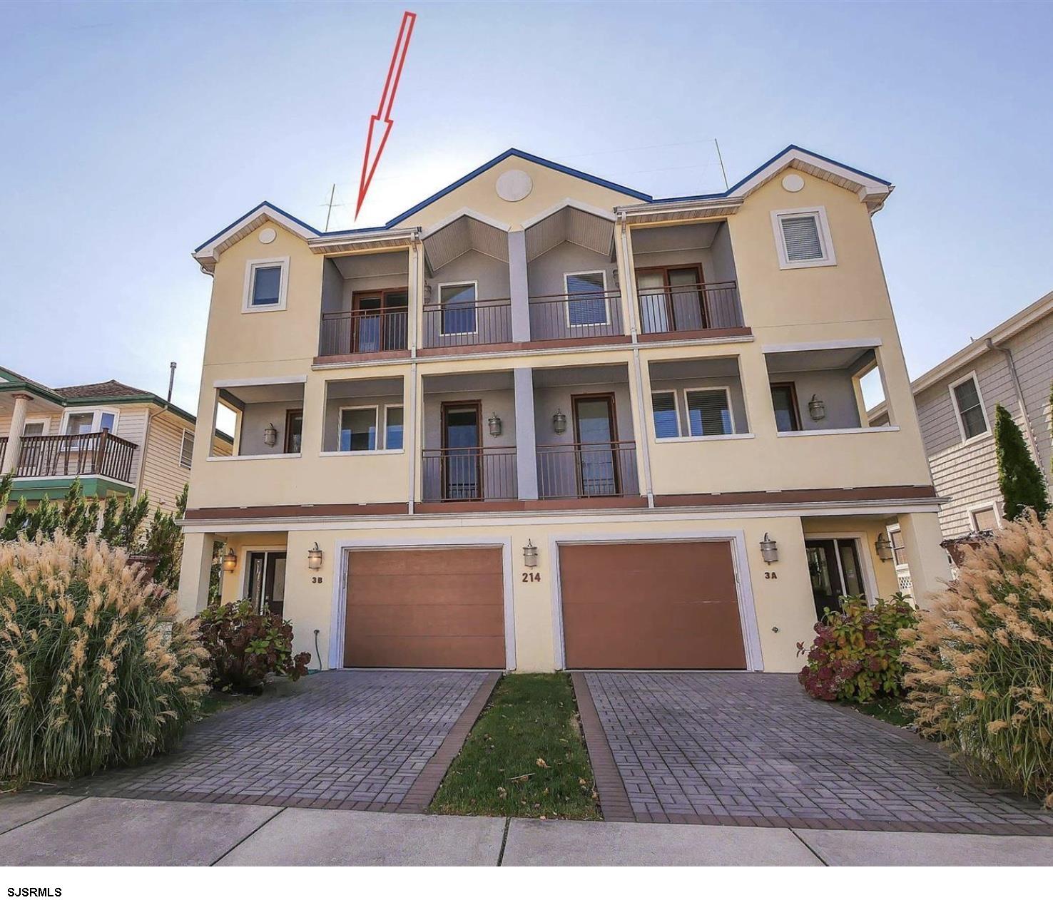 214 North Decatur Avenue, Unit 3B Margate City, NJ 08402 - Photo 2 of 41 a front view of a house with a yard and garage