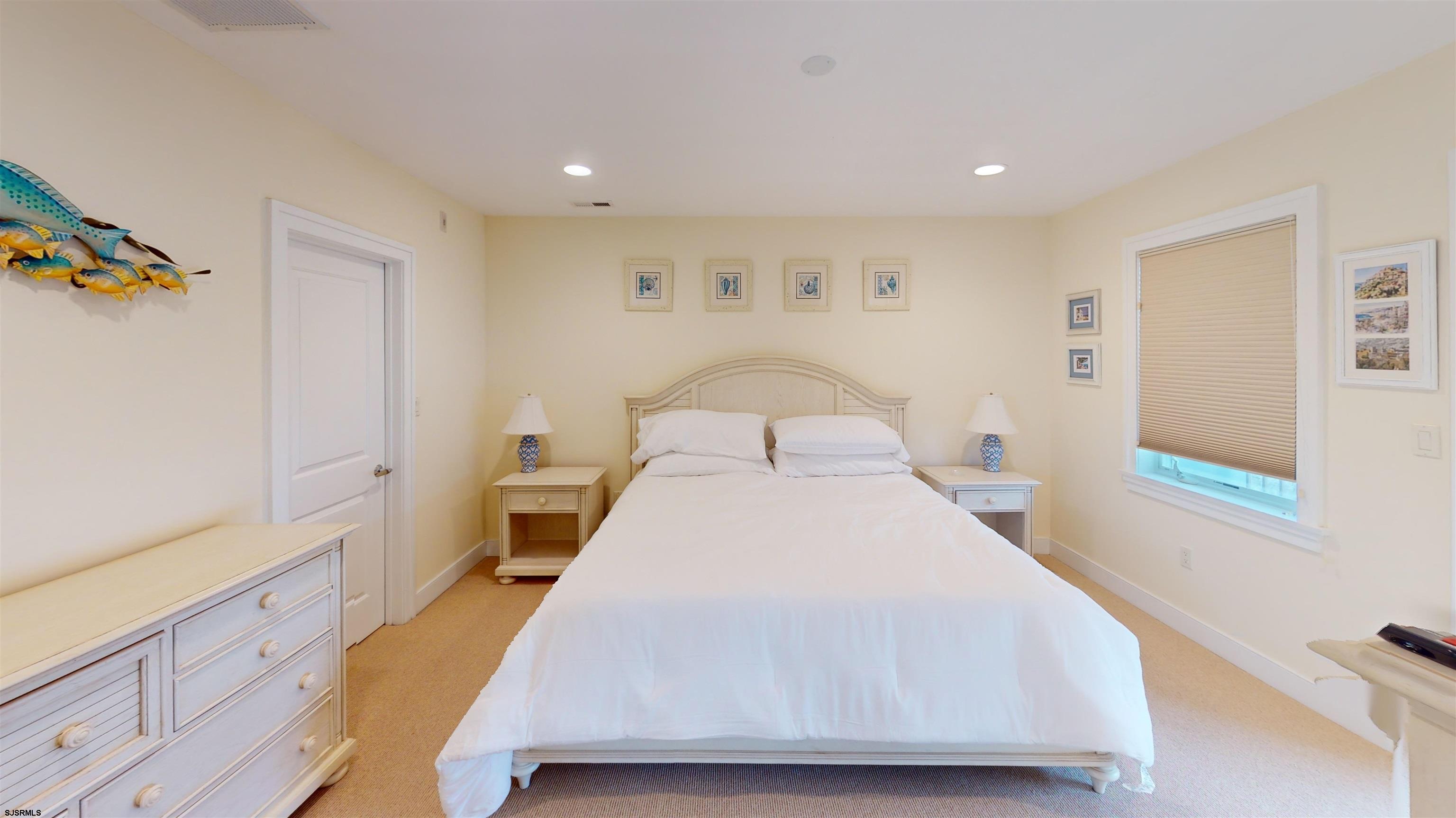 214 North Decatur Avenue, Unit 3B Margate City, NJ 08402 - Photo 24 of 41 a bedroom with a bed and a window