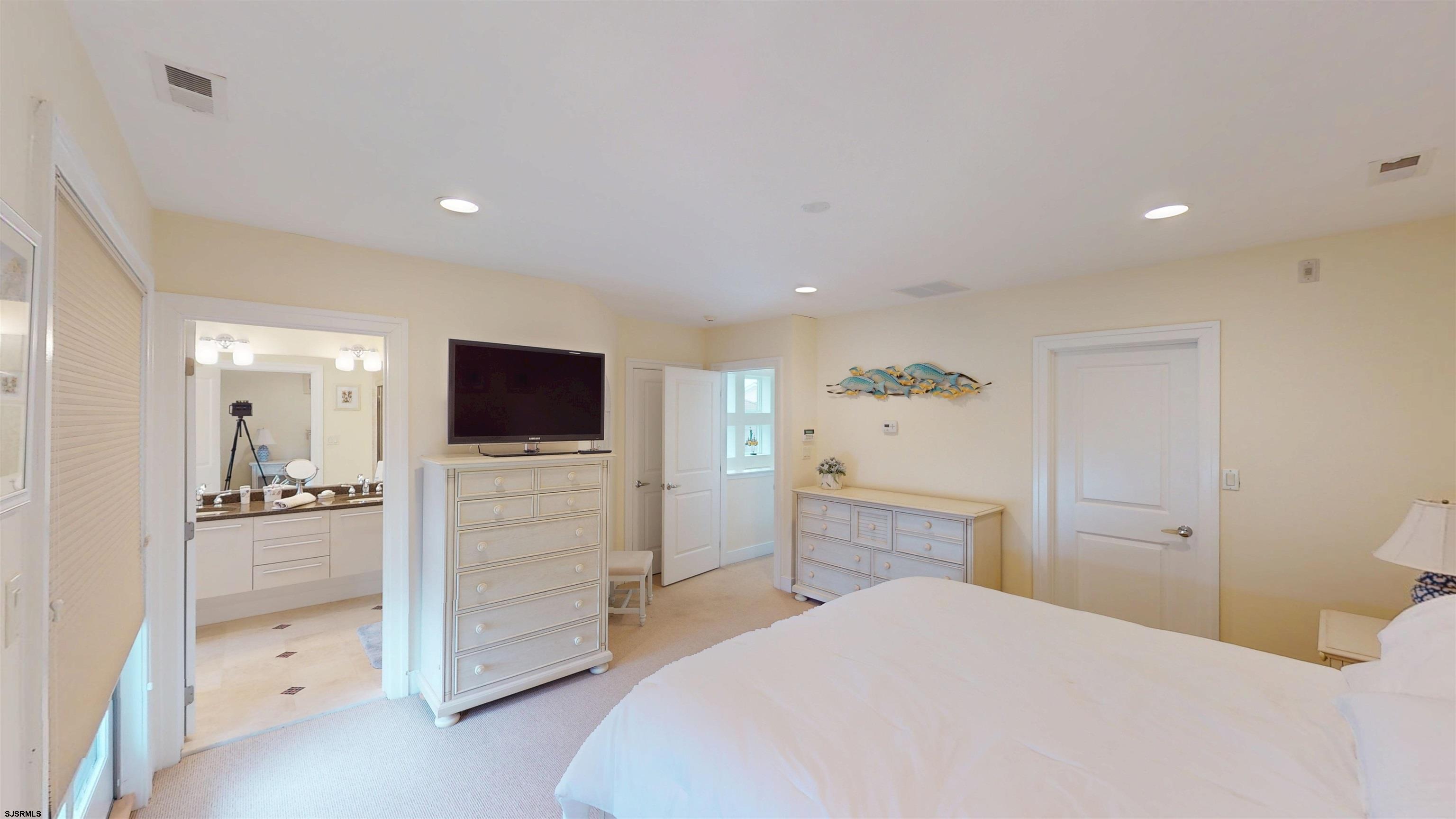 214 North Decatur Avenue, Unit 3B Margate City, NJ 08402 - Photo 26 of 41 a bedroom with a bed and a flat screen tv