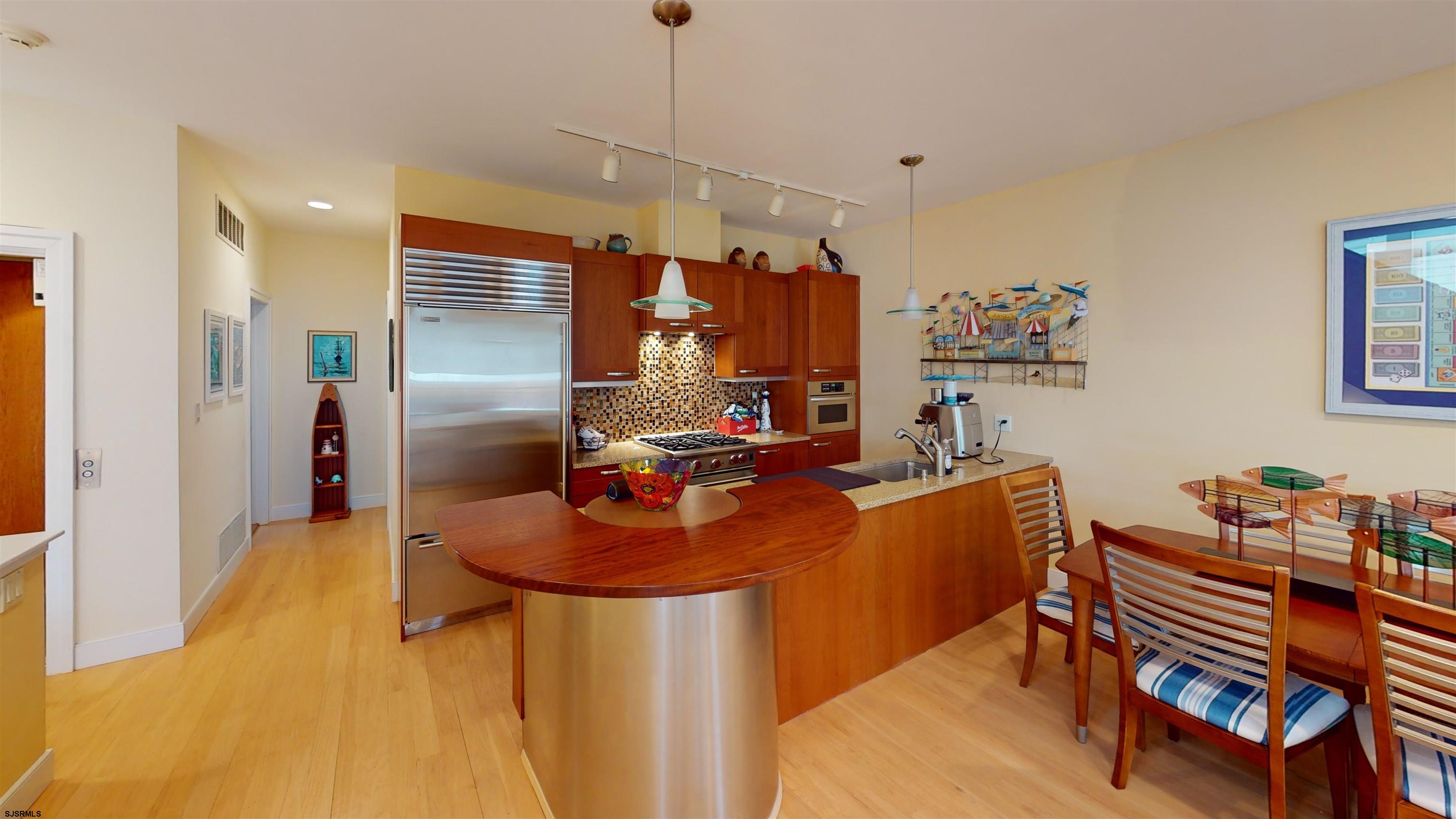 214 North Decatur Avenue, Unit 3B Margate City, NJ 08402 - Photo 8 of 41 a very nice looking dining room with kitchen island stainless steel appliances a table and chairs