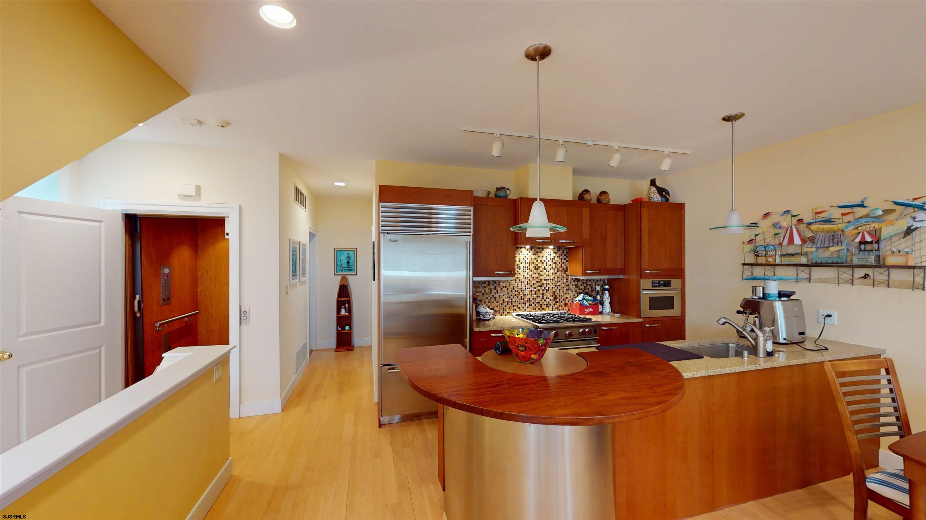 214 North Decatur Avenue, Unit 3B Margate City, NJ 08402 - Photo 9 of 41 a dining room filled with furniture and a chandelier
